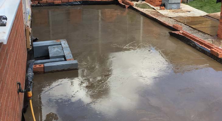 Concrete slab poured and tampered