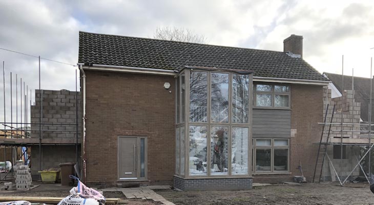 View of the front with extension blockwork wrapping around the sides.