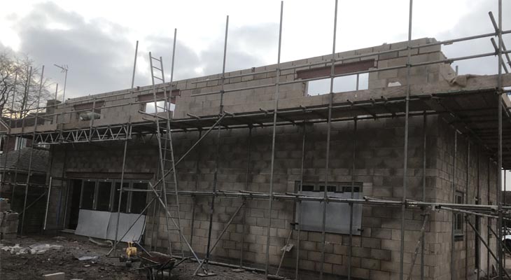 Scaffold in place building the second floor of the rear elevation.